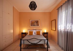 a bedroom with a bed with two candles on it at Modern retreat near Ancient Olympia and sandy beach in Káto Samikón