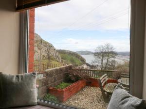a room with a window with a view of the water at 3 Bay View Terrace in Llandudno