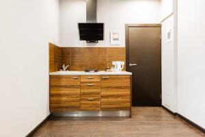a bathroom with a sink and a tv on the wall at ApartHotel Riga Self Registration & Check-in in Riga +213 photos
