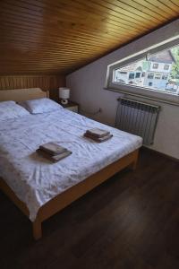 a bedroom with a bed with two towels on it at Gacka idila 2 in Otočac