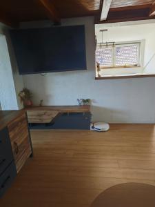 a living room with a large tv on the wall at Gacka idila 2 in Otočac