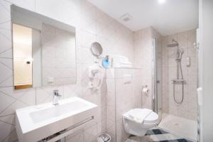 a white bathroom with a sink and a toilet at Apuntadores 8 in Palma de Mallorca +50 photos