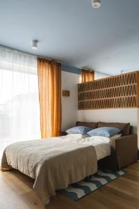 a bedroom with a large bed and a window at Złota 34 Karwia in Karwia +58 photos