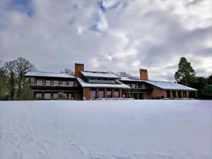 a house with snow in front of it at Sæbygaard Estate Kalundborg in Ruds-Vedby