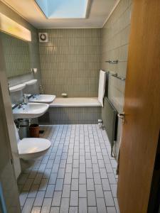 a bathroom with two sinks and a tub and two toilets at Sæbygaard Estate Kalundborg in Ruds-Vedby +22 photos