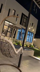 a swinging chair in front of a house at فيلا شاليه ذا ويسس in Taif