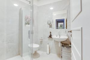 a bathroom with a shower and a toilet and a sink at Kafka Prague rooms in Prague +39 photos