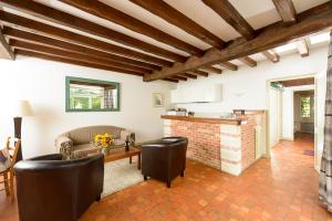 a living room with a couch and a table at Le Logis d Orgeval in Orgeval