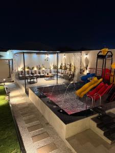 a swimming pool in a house at night at فيلا شاليه ذا ويسس in Taif