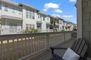 a balcony with a bench and some condos at Prominence 30A - Coastal Cottage in Panama City Beach