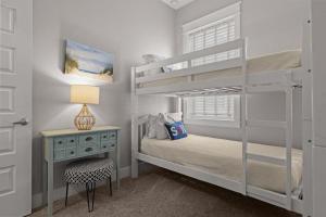 a bedroom with two bunk beds and a desk at Sea Haven At Prominence in Watersound Beach +44 photos