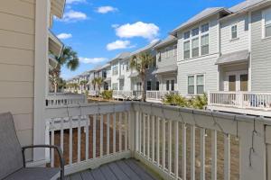 a balcony with a deck with condos at Sea Haven At Prominence in Watersound Beach