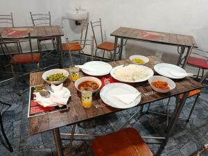 a wooden table with plates and bowls of food on it at Horizon Guest Hatton in Hatton