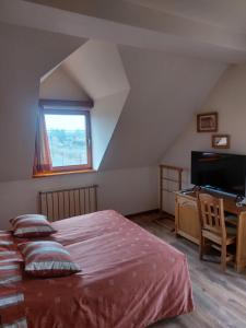 a bedroom with a bed and a desk and a window at Berki Vendéglő és Hotel in Körmend