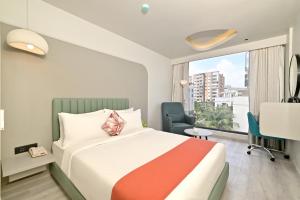 a hotel room with a bed and a window at Ira by Orchid Hyderabad Hitech City Mindspace IT Park in Hyderabad