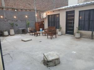 a patio with chairs and a table and a building at merlomar1 in Merlo