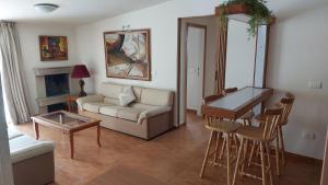 a living room with a couch and a table at Spacious 4-Bedroom Chalet - Ski and Summer in Kfardebian