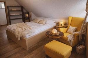 a bedroom with a bed and a chair at Chata pod kopcom in Žarnovica