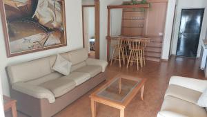 a living room with a couch and a table at Spacious 4-Bedroom Chalet - Ski and Summer in Kfardebian