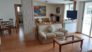 a living room with a couch and a coffee table at Spacious 4-Bedroom Chalet - Ski and Summer in Kfardebian