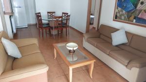 a living room with two couches and a table at Spacious 4-Bedroom Chalet - Ski and Summer in Kfardebian +12 photos