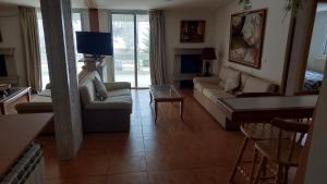 a living room with a couch and a tv at Spacious 4-Bedroom Chalet - Ski and Summer in Kfardebian