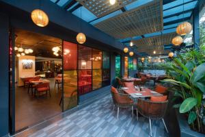 a restaurant with tables and chairs and lights at Ira by Orchid Hyderabad Hitech City Mindspace IT Park in Hyderabad