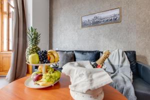 a table with a bowl of fruit on it at Kafka Prague rooms in Prague