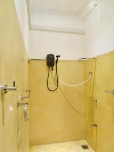 a bathroom with a shower with a camera on the wall at Costal View-Ahangama in Ahangama