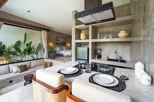 a living room with a table and a couch at Atol Villas in Uluwatu