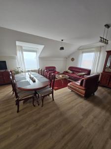 a living room with a table and chairs and a couch at Bella Vista in Stažnjevci