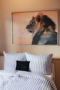 a picture of a lion on the wall above a bed at Seabreeze Suite in Füssen