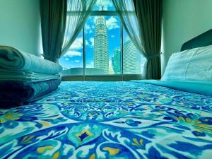 a bedroom with a bed with a view of a city at vortex suites klcc by park view in Kuala Lumpur