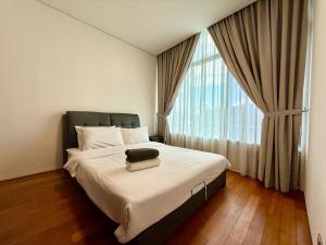 a bedroom with a bed and a large window at vortex suites klcc by park view in Kuala Lumpur