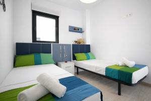 a bedroom with two beds and a window at AL045 Pinada Beach III La Mata in La Mata +53 photos