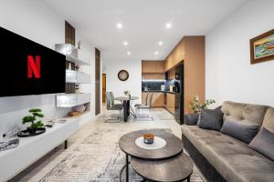 a living room with a couch and a table at Plovdiv Luxury 1BR * Free Parking * Rowing Base in Plovdiv
