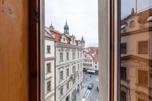 a view of a city street from a window at Kafka Prague rooms in Prague