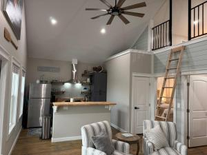 a kitchen with a refrigerator and a ceiling fan at Beach House with Breathtaking Sunsets - Perfect for Couples and Families! in Bolivar Peninsula