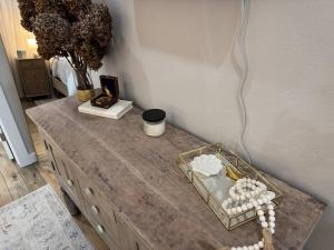 a table with a wooden table with a vase of flowers at Beach House with Breathtaking Sunsets - Perfect for Couples and Families! in Bolivar Peninsula