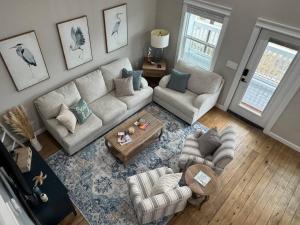 a living room with a couch and a table at Beach House with Breathtaking Sunsets - Perfect for Couples and Families! in Bolivar Peninsula