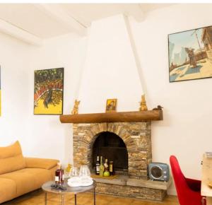 a living room with a fireplace and a couch at Villa Emmanuella in Centuri
