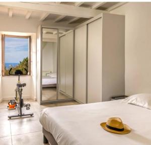 a bedroom with a bed with a hat on it at Villa Emmanuella in Centuri