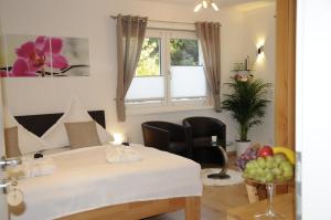 a room with a bed and a table with fruit on the floor at Pension Dietrich in Dobel