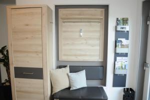 a room with a bench and a wooden door at Pension Dietrich in Dobel