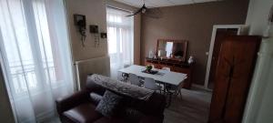 a living room with a table and a couch at Villa Mon Repos 3 in La Bourboule