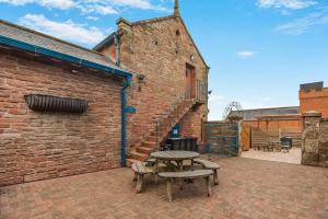 a brick building with a picnic table and a grill at 1 Bed in Brampton oc-g34638 in Brampton