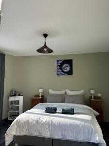 a bedroom with a large bed with two bags on it at Des Ciappes et des Fées in Menton