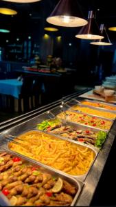 a buffet line with many different types of food at Rafaelo Deluxe Hotel & Spa Shengjin in Shëngjin