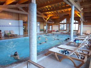 a large pool with people swimming in it at Les Airelles A21 in Les Menuires