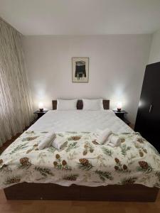 a bedroom with a large white bed with flowers on it at Main Square APT with Stone Bridge & Old Bazaar View in Skopje